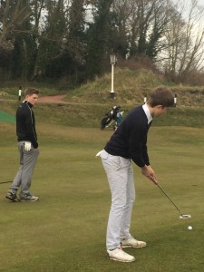 Alex Duckworth putts at 16 at Hesketh Golf Club watched by his Southport and Ainsdale club colleague Charlie Holland