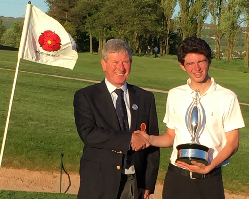 CAPTION:  Greg Holmes (Royal Birkdale GC) is presented with the Lancashire County Boys Championship trophy by Lancashire Union of Golf Clubs President Michael Lay
