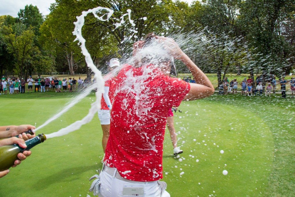 Maclaren is showered with champagne on the 18th green at Queanbeyan Golf Club. Picture by TRISTAN JONES