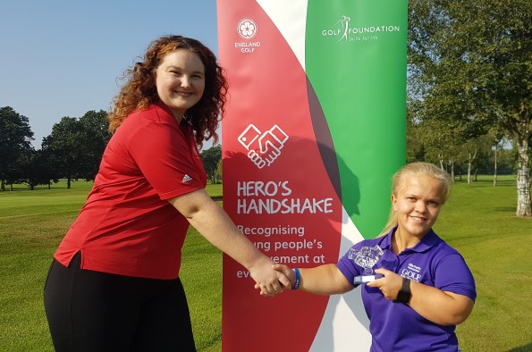 Hagley Golf Club’s Ellie Perks (right) receives her England Golf Hero’s Handshake Award from the scheme’s young ambassador Emily Furniss.